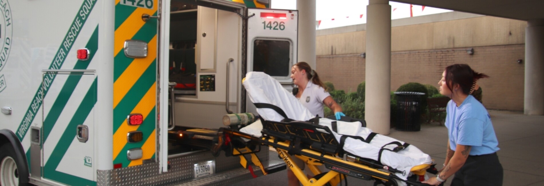Paramedics loading empty stretcher into Virginia Beach EMS ambulance