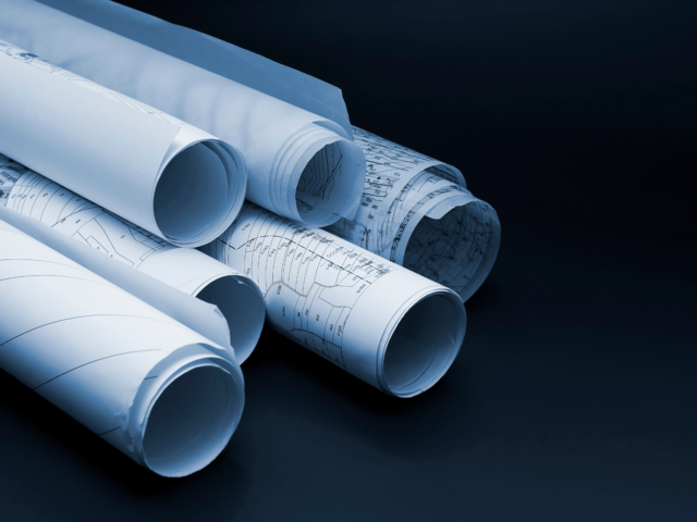 Group of rolled up construction documents blueprints and drawings