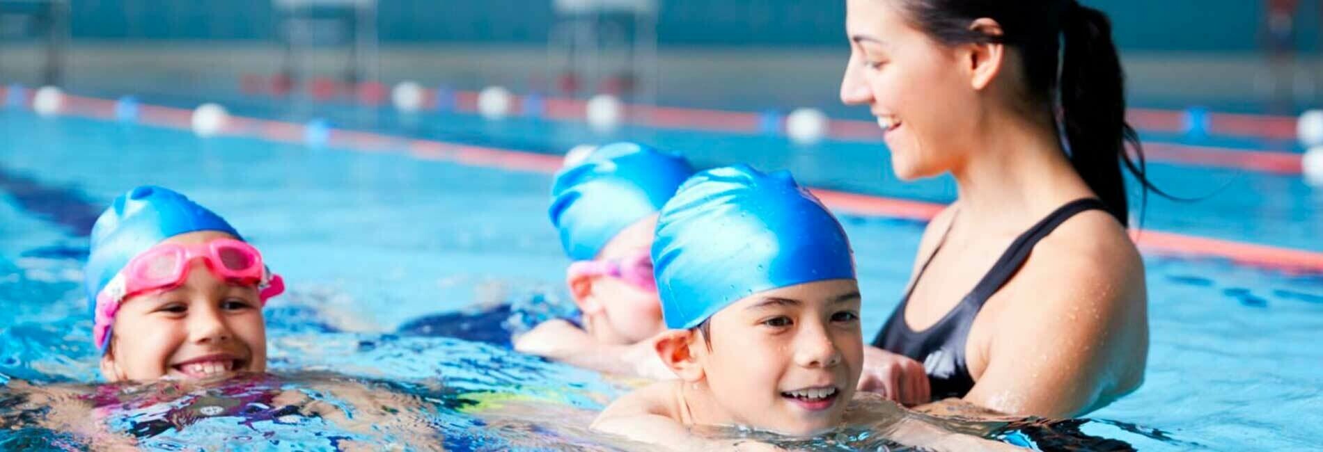 Swimming Instructor Giving Lessions to Children