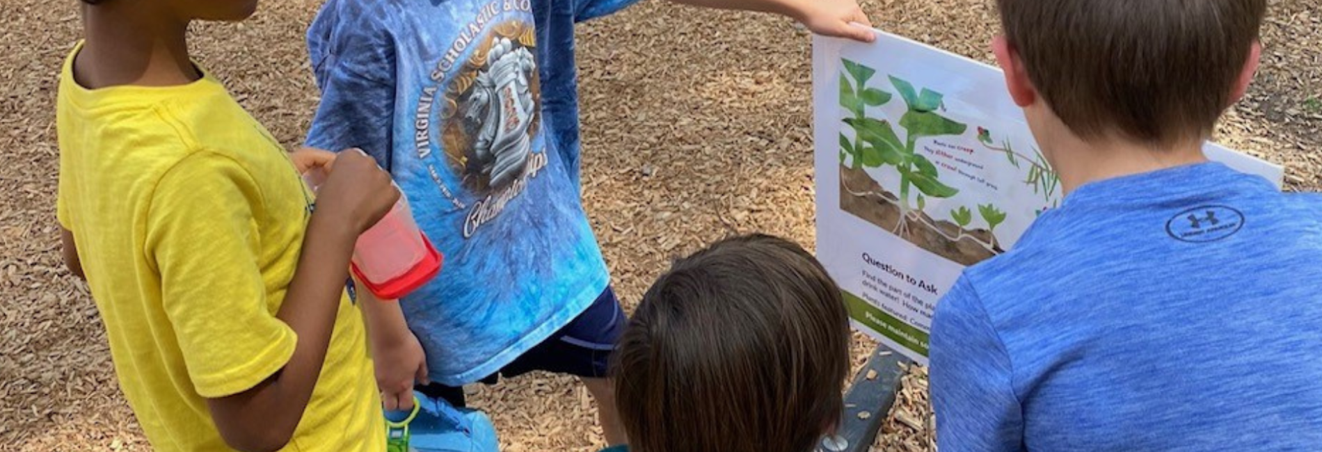 Children holding Story Walks Sign