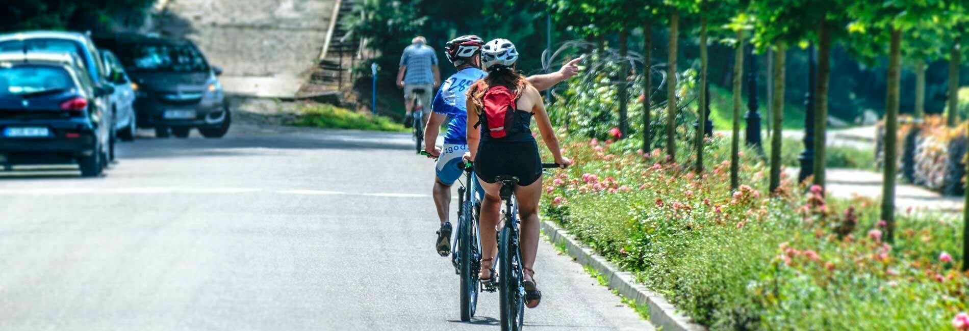 Couple Riding Bikes Down Street