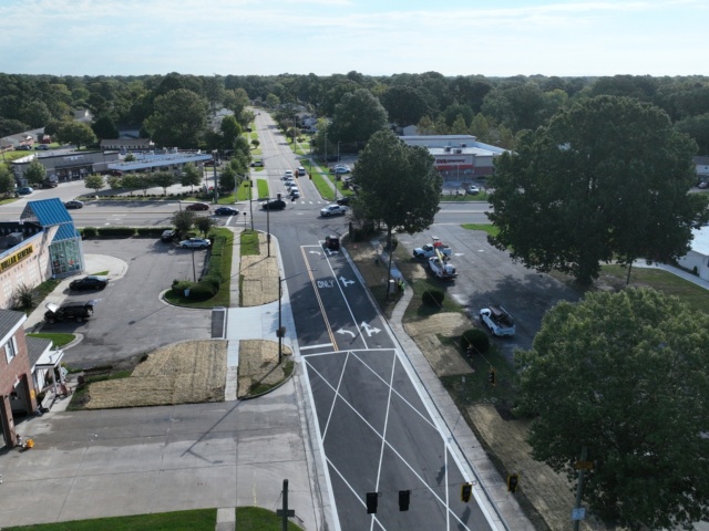 Aerial view showing finished paving and lane markings where the newly installed increased capacity parallel storm drain system connected to the existing drainage system