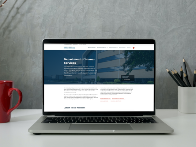 Human Services website on laptop on table resource guide featured navigation
