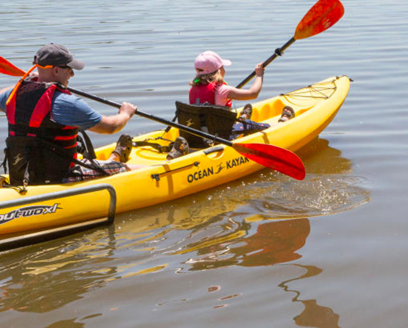 Father and Child Launching Kayak into Water