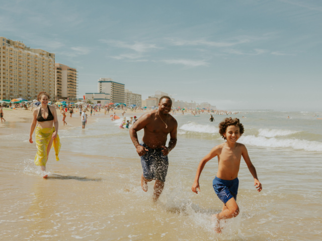 Parents running with young child at Oceanfront